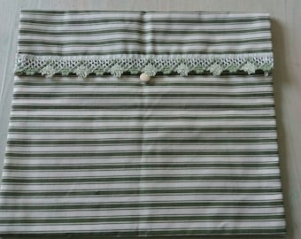 Pouch has green and white stripes and lace