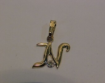 10k yellow gold letter *N* with small diamond-