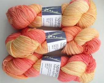 Hand dyed yarn super wash merino, salmon, peach, with red flecks in fingering weight