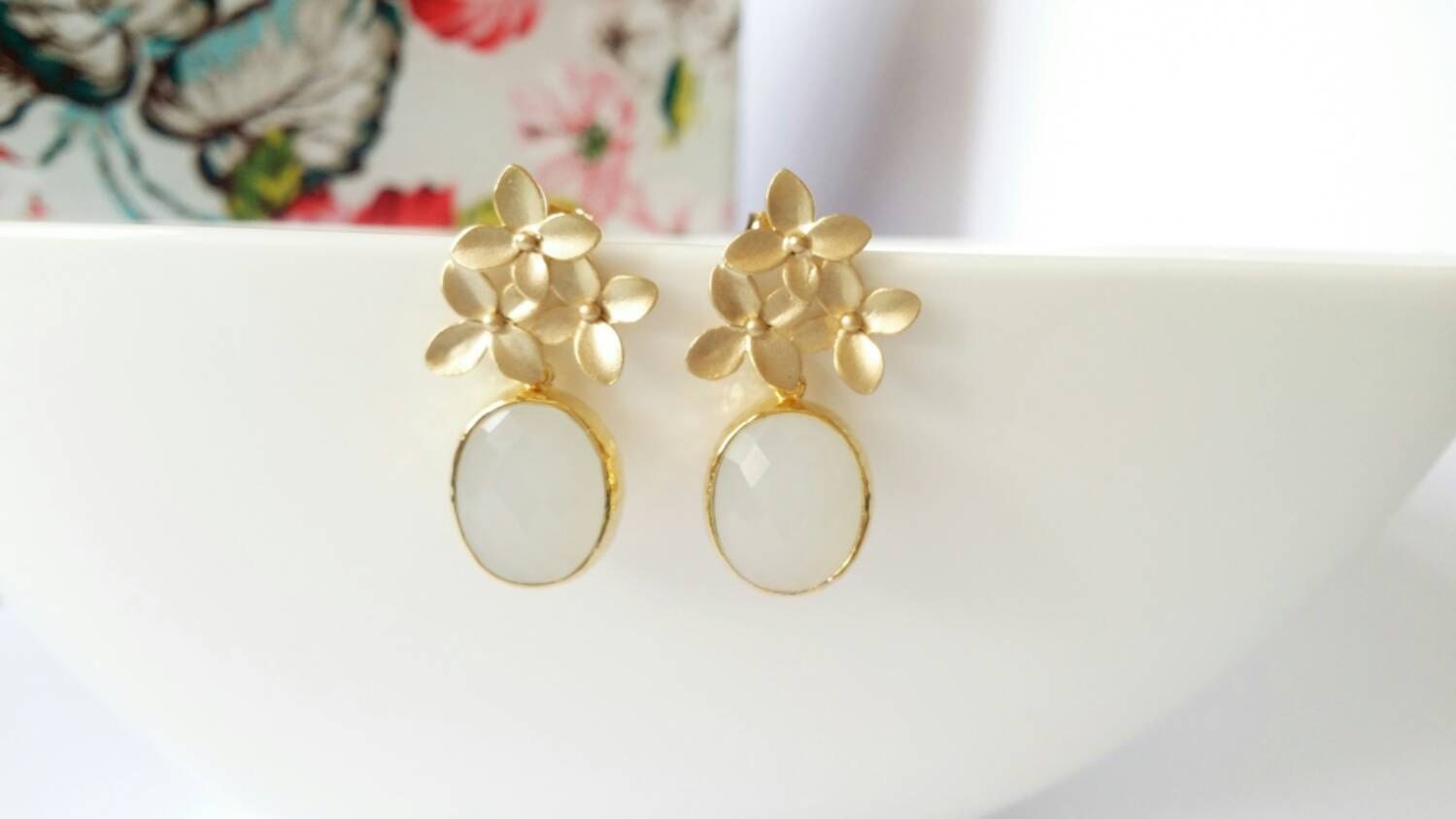 Gold flower stud earrings with oval drop
