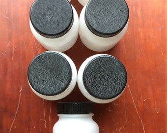Lot of 7 plastic liquid sample bottles with a hard plastic screw lid