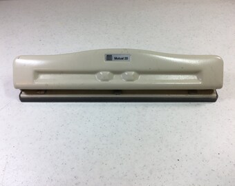 Beige Acco Three Hole Punch Adjustable with Plastic Tray to Catch the Holes 11 & 3/8 Inches Long 2.25" Wide Previously 10 Dollars ON SALE