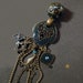 Pendant with blue enameled bronze metal charms