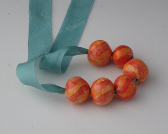 Red and tangerine small striped round bead