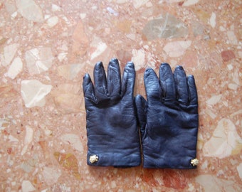 black leather gloves with a golden turtle button