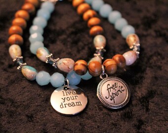 A Beautiful 2 Piece Set of Wood and Glass Bead Bracelet with Charms was 20.00