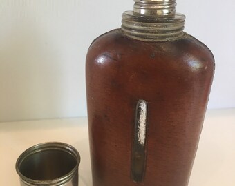 Antique leather and glass hip flask with shot cup