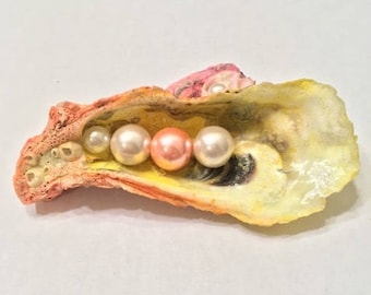 Sunset-colored shell sculpture with pearls
