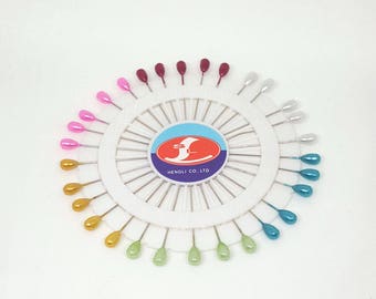 Droplet shaped head pin wheel. 30 assorted coloured pins with pearlescent heads. Extra long