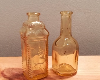 Two vintage Yellow Amber Glass Wheaton Bottles, Phila Berring's Apple Ginger and Rogers Brothers 1850 Seal