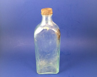 R.V. Pierce MD Buffalo, New York antique dug glass medicine bottle.. early 1900's... clear glass with a light green tint... original cap