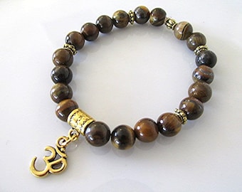 Tiger eye bracelet gemstone bracelet om charm yoga bracelet solar plexus chakra bracelet boho bracelet new age meditation bracelet healing.