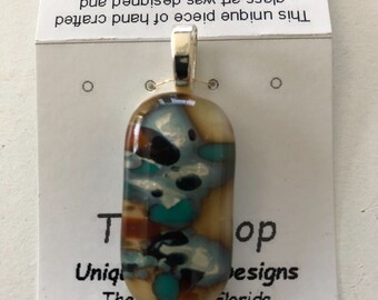 Fused glass pendants with silver inclusions