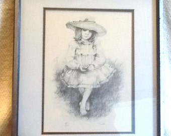 Signed and numbered print of an illustration by American artist Jennie Tomao. Barefoot young girl, straw hat w/flowers. 138/200. Framed.