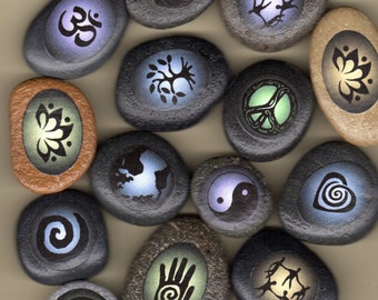 boda stones with symbols; spiral heart, healing hand, peace, yin yang, lotus, tree, community dancers, earth, spiral, ohm