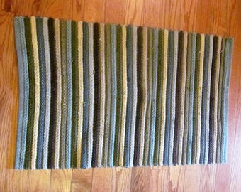 Rag rug.Woven greens and browns stripes pattern.Oblong