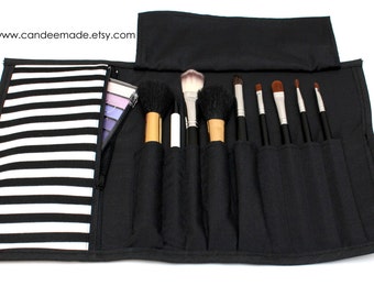 Black and white striped Brush Roll With Zippered Pocket.