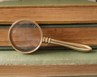 Vintage brass pocket sized (small) magnifying glass. Solid brass with clear acrylic convex lens. Removable handle.
