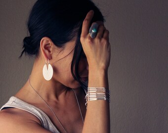 Contemporary silver bracelet handmade of a multitude of individual hand cut silver bars connected into eight strands - "Channel Bracelet"