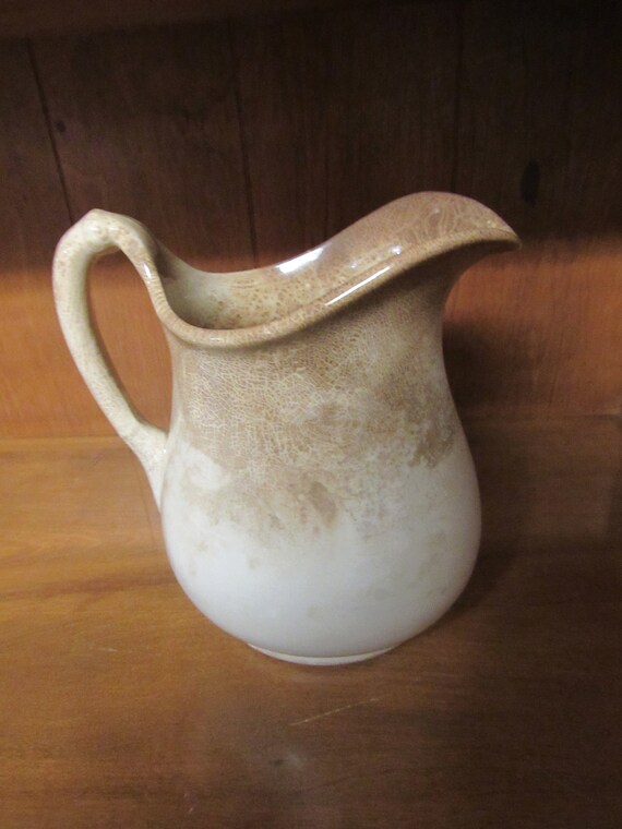 Antique brown and white pitcher