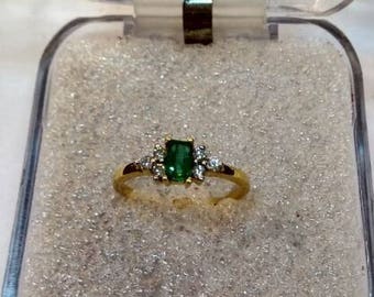 A beautiful ring is made in natural emerald cut shape emerald with diamonds in 14k hallmarked gold