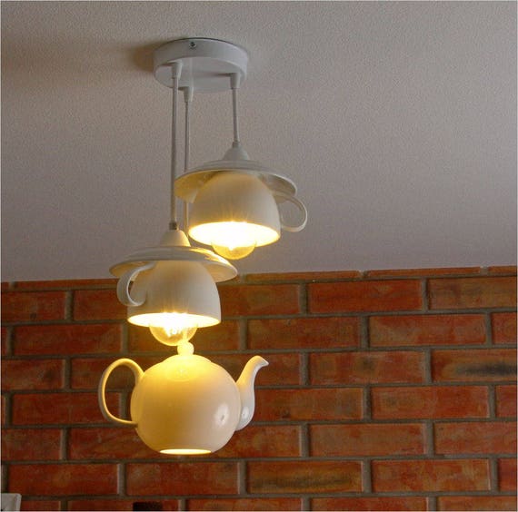 Porcelain pendant lighting of teapot and china cup. Dishes