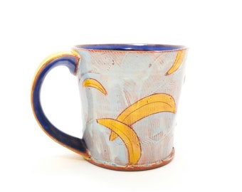 Puffy banana themed Earthenware mug. Wheel thrown, food safe mug made by Kaitlyn Brennan / Brennan Pottery. This is a mug perfect for coffee