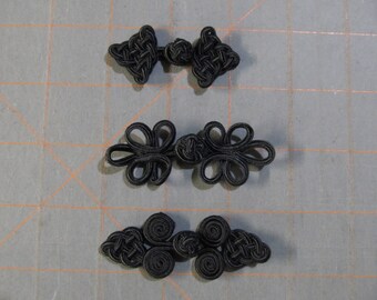 Black frog closures - small: 2"x1" and 2.75"x1" - new in package - 3 dollar flat shipping rate - sewing and crafts