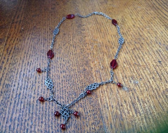 Handcrafted blackened sterling and ruby red glass neclace.