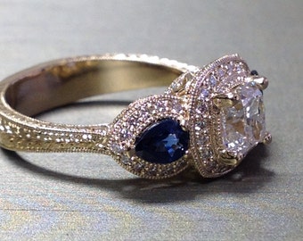 Diamond and blue sapphire three stone engagement ring