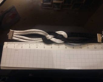A black and white sailor knot bracelet.