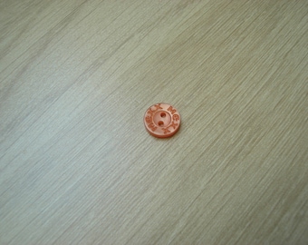 small orange Pearly button shape round with inscription