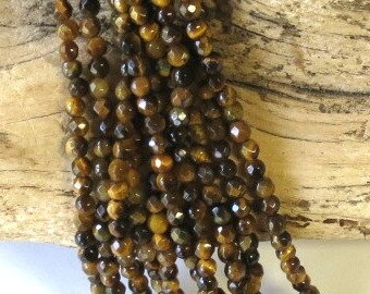 Tigereye - Faceted Tiger Eye - 4mm - Round - 15 1/2 Inch Strand of 103 Beads