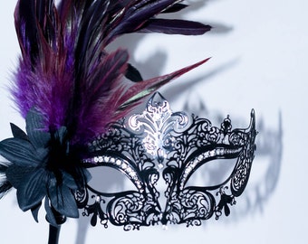 masquerade mask, masquerade mask with a stick and purple feathers, laser cut metal mask black and white crystals