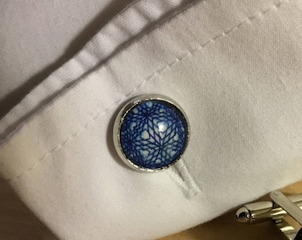 A pair of blue geometric patterned cufflinks