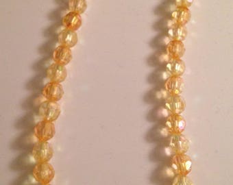Yellow and orange beaded necklace with orange rose pendant