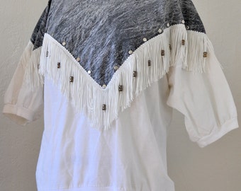 Denim Poncho on White Sweater. Fringe Shirt.