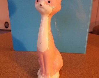 Pink and white cat figurine