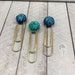 One Blue-Green Round Iced Clip