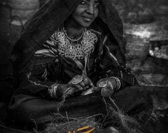 Tuareg women sewing a mattress with her hands