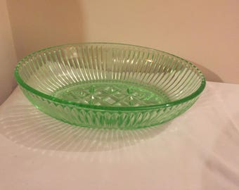 A heavy, vintage, uranium -green pressed glass bowl.