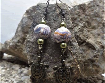 Earrings metal turtle and bead made of polymer clay.