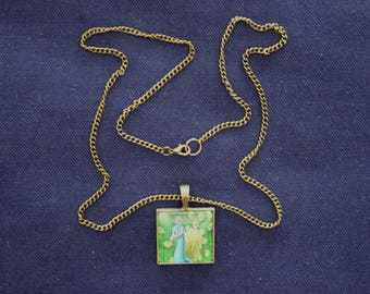 Necklace blue Peacock on a green background