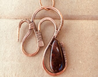 Copper wire wrapped pendant with garnet bead.