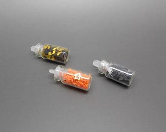 3 small glass vials, orange, silver and gold glitter