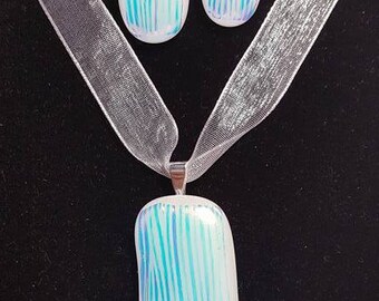 An aqua colored fused dichroic glass pendent