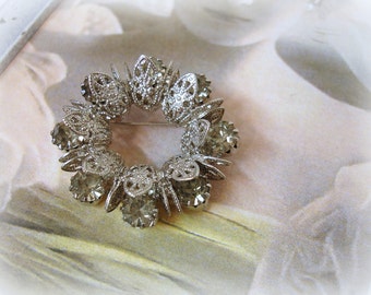 vintage rhinestone wreath brooch . silver tone filigree prong set black diamond rhinestones circa 1960s