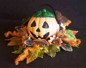 Retro Jack o lantern Halloween decoration floral arrangement vintage old fashioned spooky pumpkin flowers centerpiece