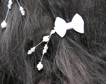 Ornaments with white bow and pearls bridal hair