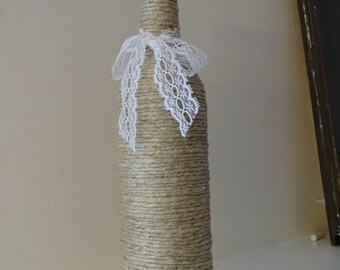 Twine wrapped wine bottle with lace bow